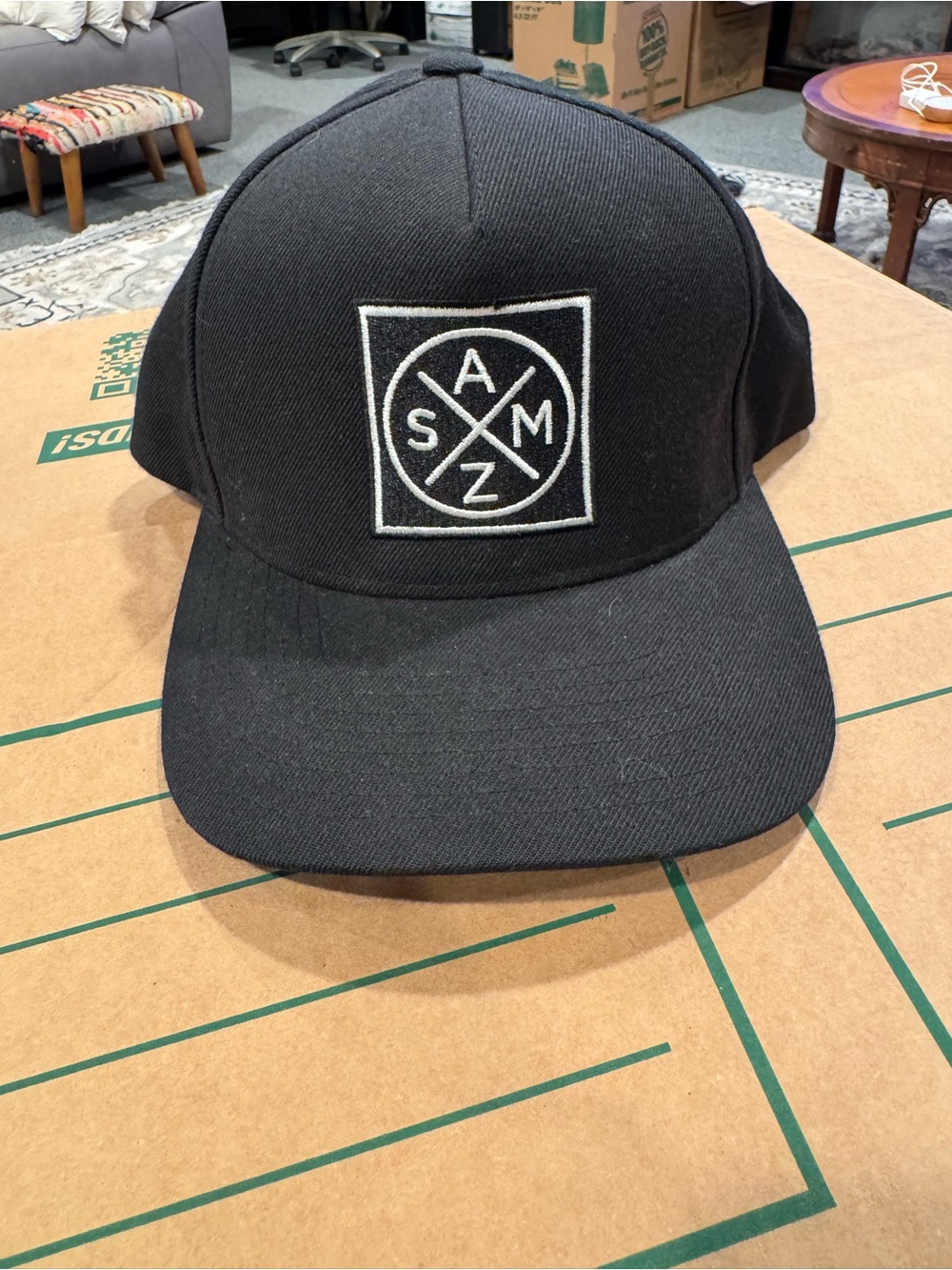 The Classic Black Snapback Hat with White Embroidered Logo